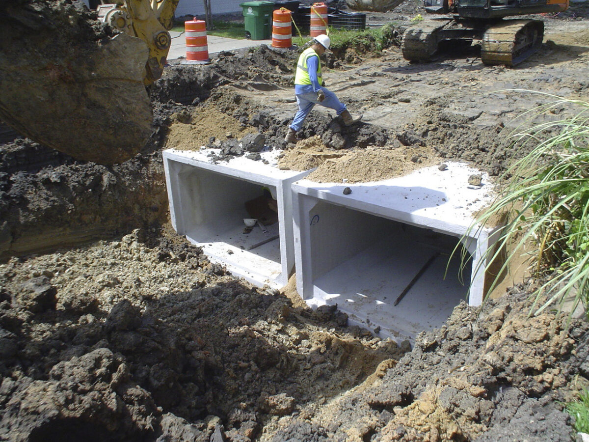 Engineer standing on drainage pipes