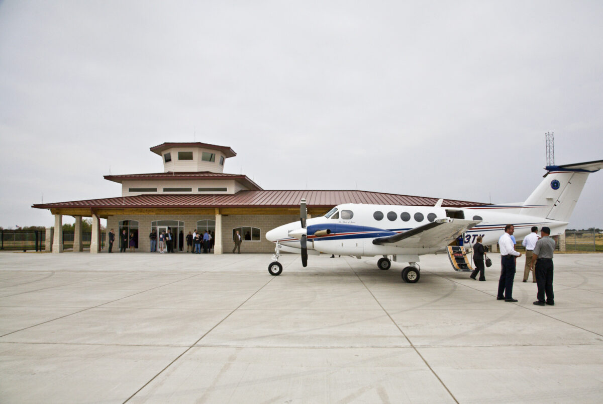 airplane and people in front of terminal