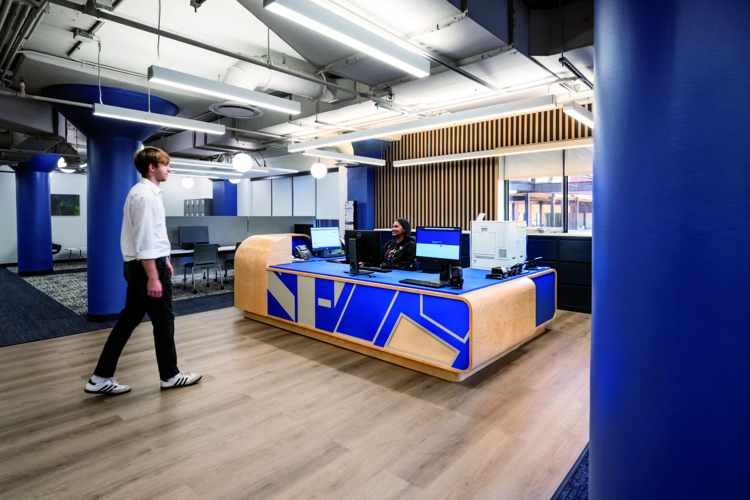 young man walking up to desk